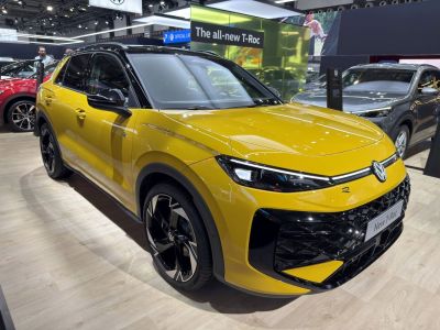 Yellow SUV front and side view with sharp headlights and alloy wheels