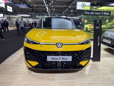 Yellow SUV front with sleek LED headlights and textured grille