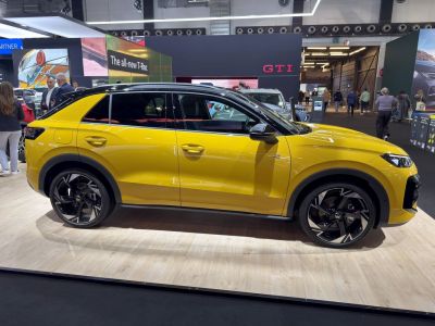 Side profile of yellow compact SUV with sporty alloy wheels