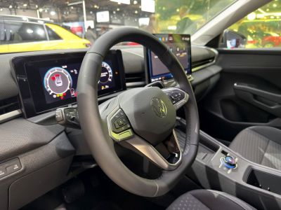 Modern steering wheel and dual digital instrument panels in a car interior