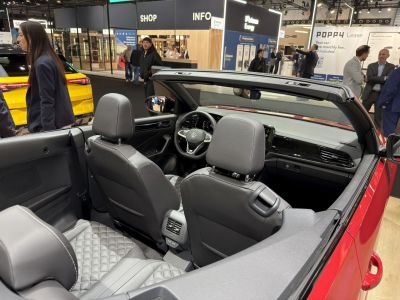 Interior view of open roof convertible with quilted leather seats and modern dashboard