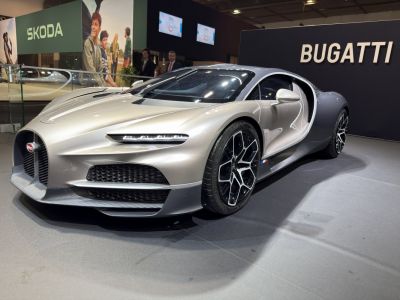 Aerodynamic front and side view with futuristic headlights and detailed grille.