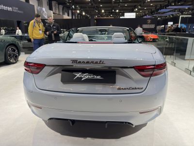 Rear view of a luxury convertible with taillights and open roof