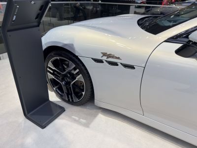 Side vent with triple grills and modern black multi-spoke wheel