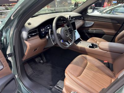 Luxury brown leather seats with digital dashboard and modern controls