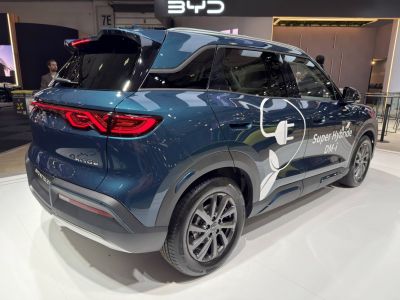Rear side view of a hybrid SUV with unique taillights and electric plug graphic.