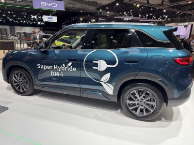 Side view of hybrid SUV with electric plug graphic and modern rim design