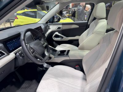 Modern car interior with digital dashboard and light leather seats