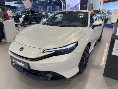 Sleek front view with LED headlights of a modern hybrid sports coupe.