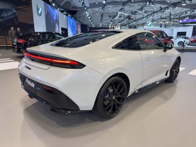Sleek modern coupe rear and side view with black wheels
