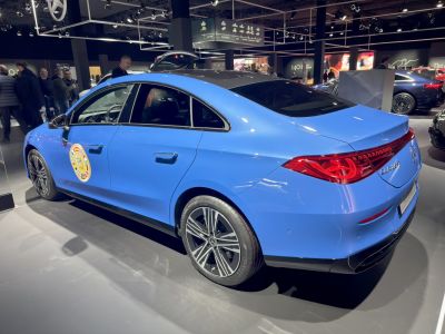 Blue four-door saloon showing rear and side with tail lights and alloy wheels