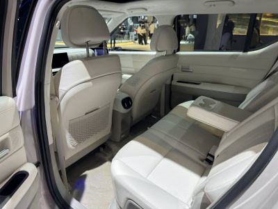 White leather rear seats with folding armrest in spacious car interior