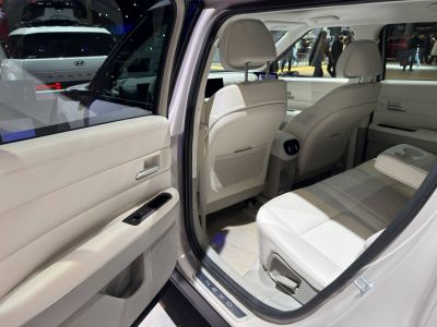 Spacious rear passenger seats with light upholstery and door interior