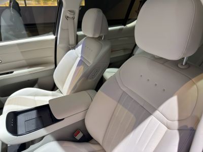 Premium leather seats with modern center console and wireless charging.