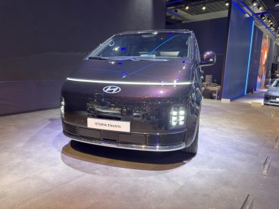 Front view of electric vehicle with distinct LED headlights and minimal grille