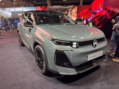 Front view of electric SUV with sleek headlights and modern grille