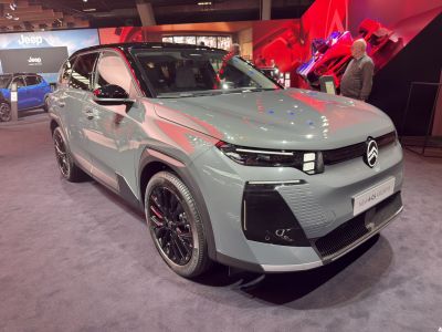 Front and side view with modern headlights and black alloy wheels.