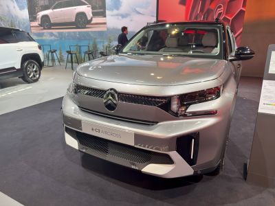 Front view with sleek LED headlights and futuristic grille design.