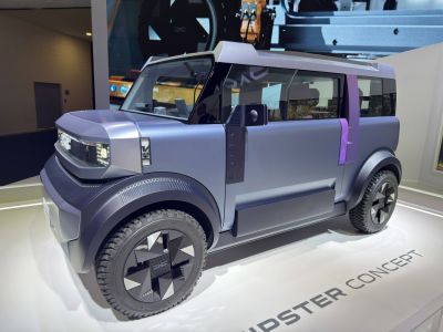 Futuristic boxy SUV with angular body and unique cross-pattern wheels
