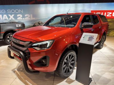 Red pickup truck with black bull bar and off-road tires