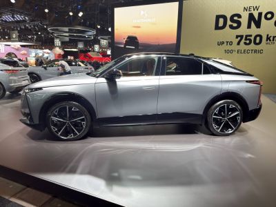 Side profile of a sleek electric sedan with aerodynamic design and large wheels