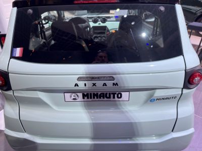 Rear view of compact electric microcar with eMINAUTO badge