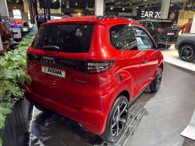 Rear view of a glossy red subcompact SUV with sporty wheels and tinted windows.