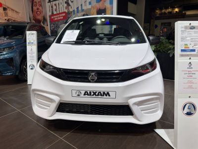 Front view showcasing sleek headlights and grille of a compact microcar.