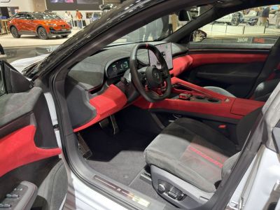 Digital dashboard and red-accented sporty interior with modern controls