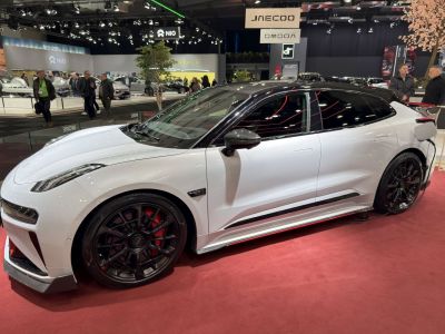 White EV with black roof and multi-spoke black wheels