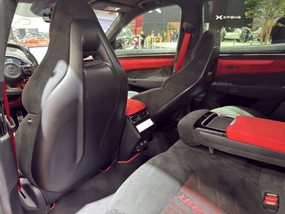 Interior with carbon fiber sport seats and red-accented luxury design