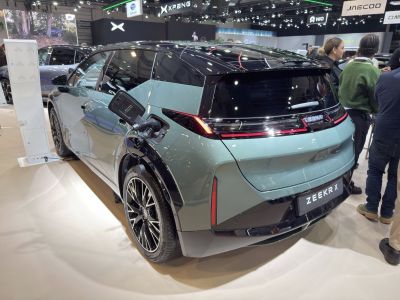 Rear view of electric SUV charging with modern alloy wheels
