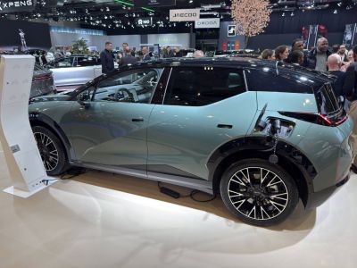 Electric SUV side view with charging port and multi-spoke wheels
