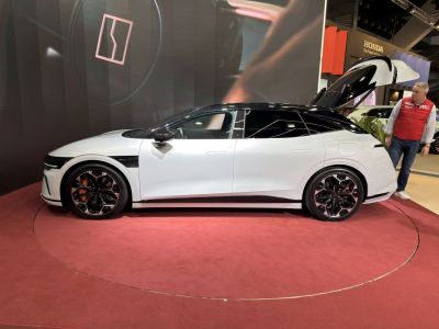 Side profile of electric SUV with gullwing rear door open