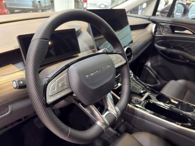 Perforated leather steering wheel with dual digital screens in black modern interior