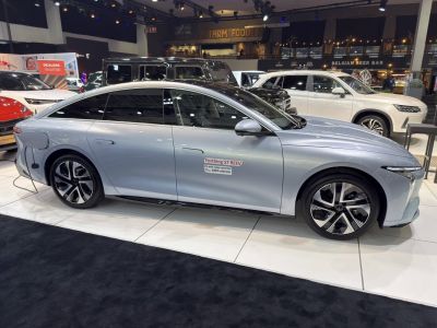 Side profile of sleek electric sedan with flush door handles and alloy wheels