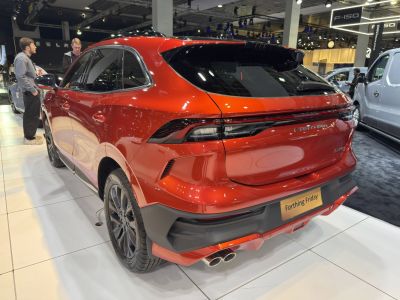 Rear view of red SUV with sleek tail lights and dual exhaust pipes