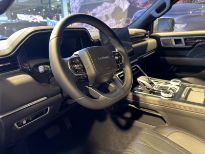 Steering wheel with controls and advanced center console in modern car interior