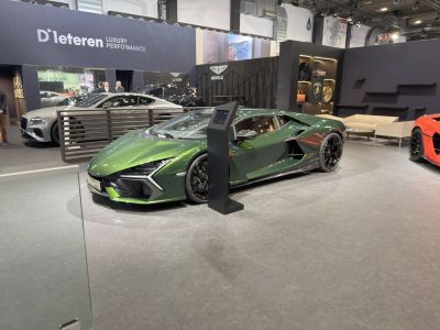 Green sports coupe with aggressive front fascia and aerodynamic body.