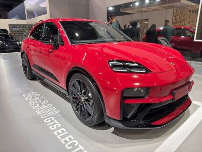 Red electric SUV with sporty front and dark alloy wheels