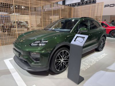 Front and side view of electric SUV with distinct headlights, wheels