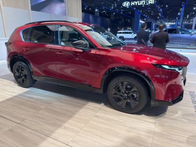 Side profile of a red SUV with black alloy wheels