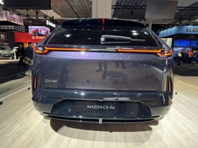 Rear view of Mazda CX-6e with sleek tail lights and modern design.