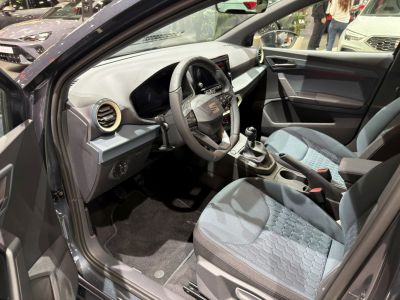 Sporty steering wheel with manual gearbox and ergonomic seats in compact car interior