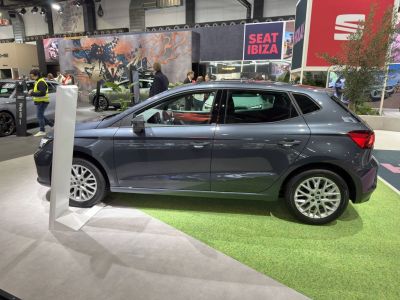Side profile of a modern compact hatchback with alloy wheels and tinted windows.