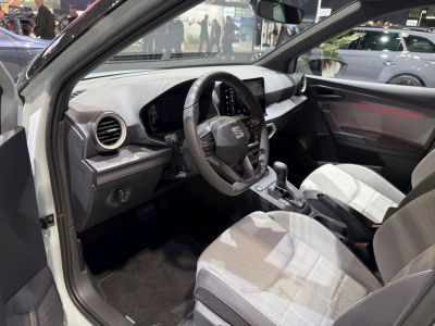 Modern steering wheel and digital instrument cluster in a compact car interior