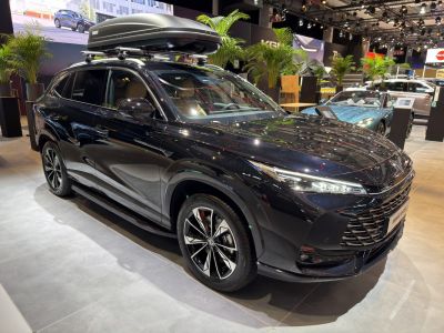 Black SUV with sleek design and roof cargo box