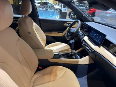 Beige leather seats and digital touchscreen dashboard in electric SUV interior