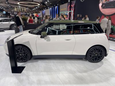 Side profile of compact electric vehicle with black wheels and contrasting roof