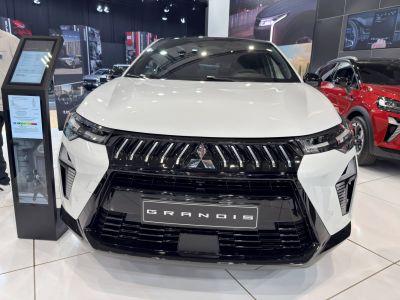Front grille and sharp headlights of a sleek car
